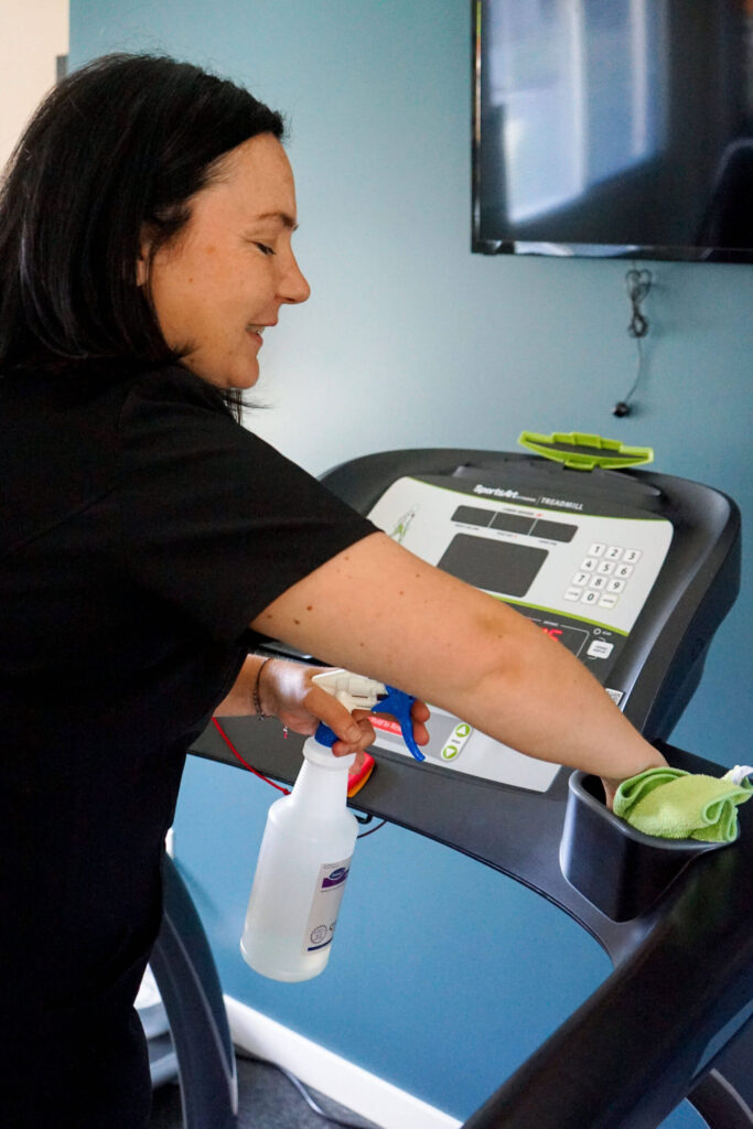 Good Sorts cleaning crew member cleaning fitness equipment