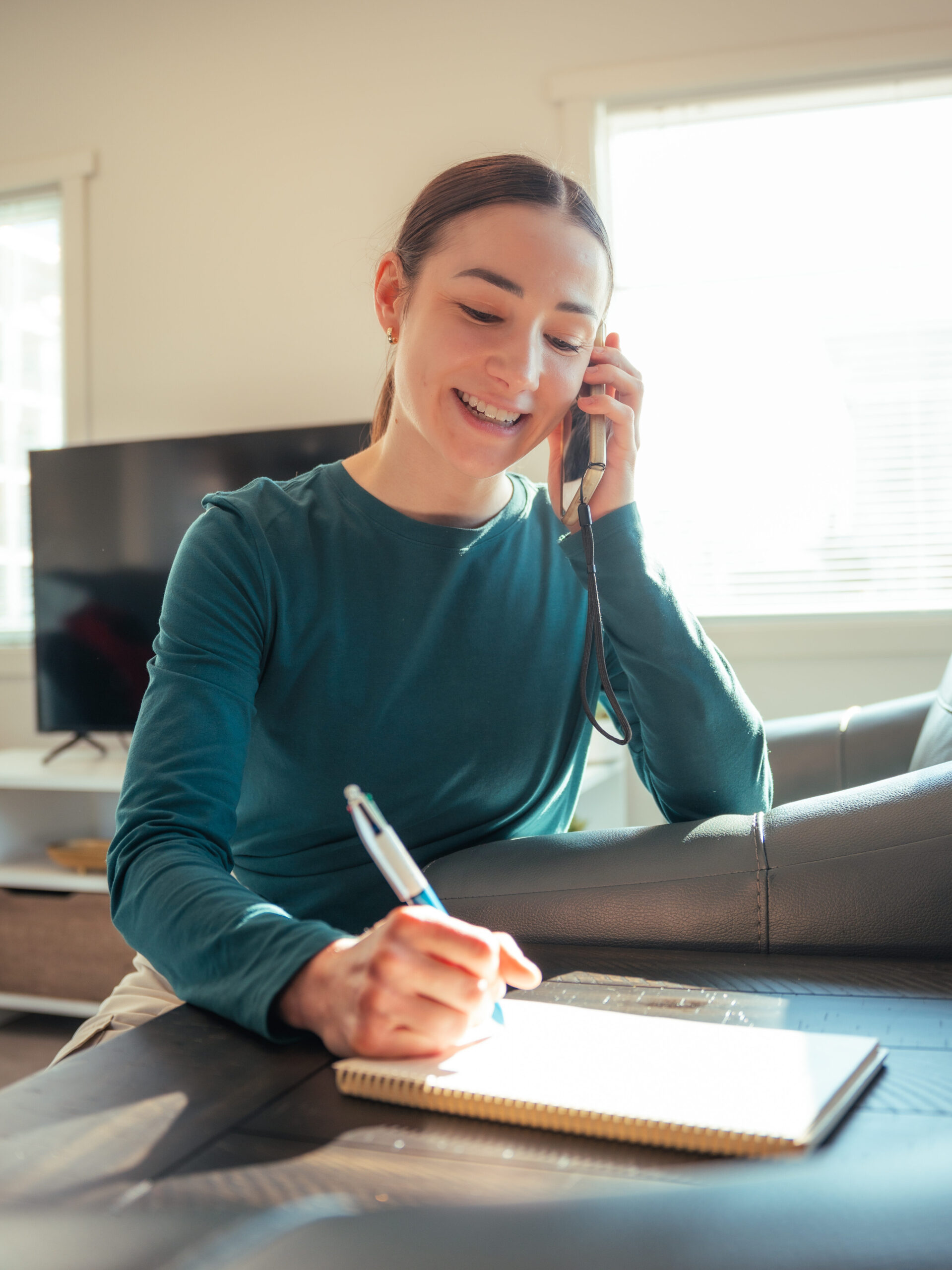 Smiling woman creating cleaning checklist inside office lobby