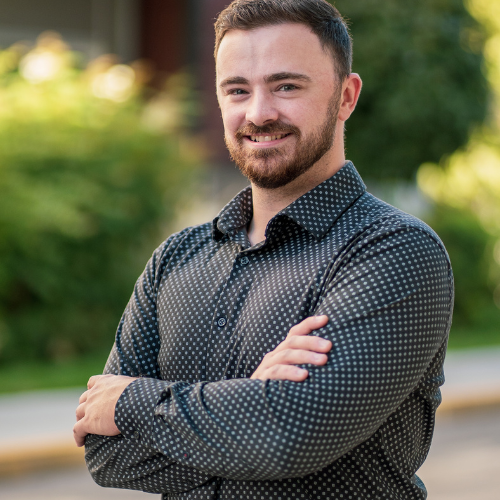 Jared Brown, Account Executive at Good Sorts Property Services, smiling in nature