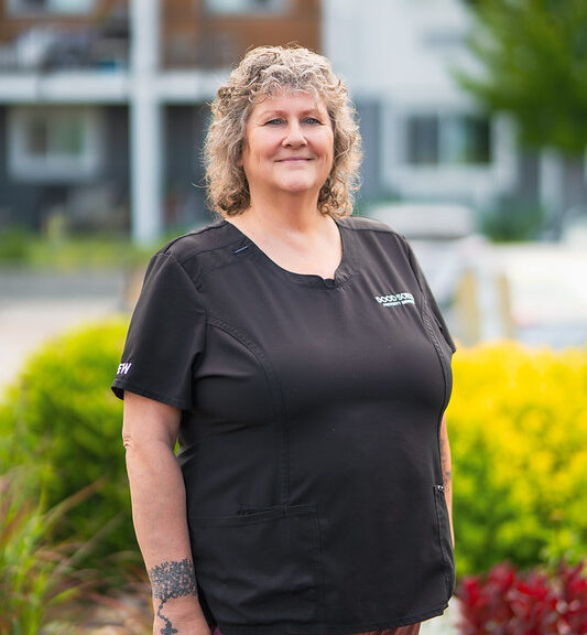 Kimberly Bussey, Quality Assurance & Training Coordinator at Good Sorts Property Services, smiling in nature