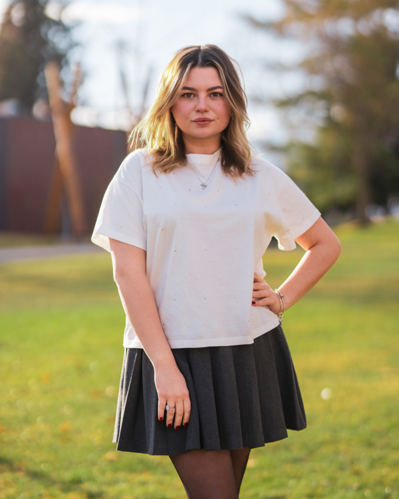 Good Sorts Property Services Assistant Operations Coordinator smiling at camera with Kelowna backdrop
